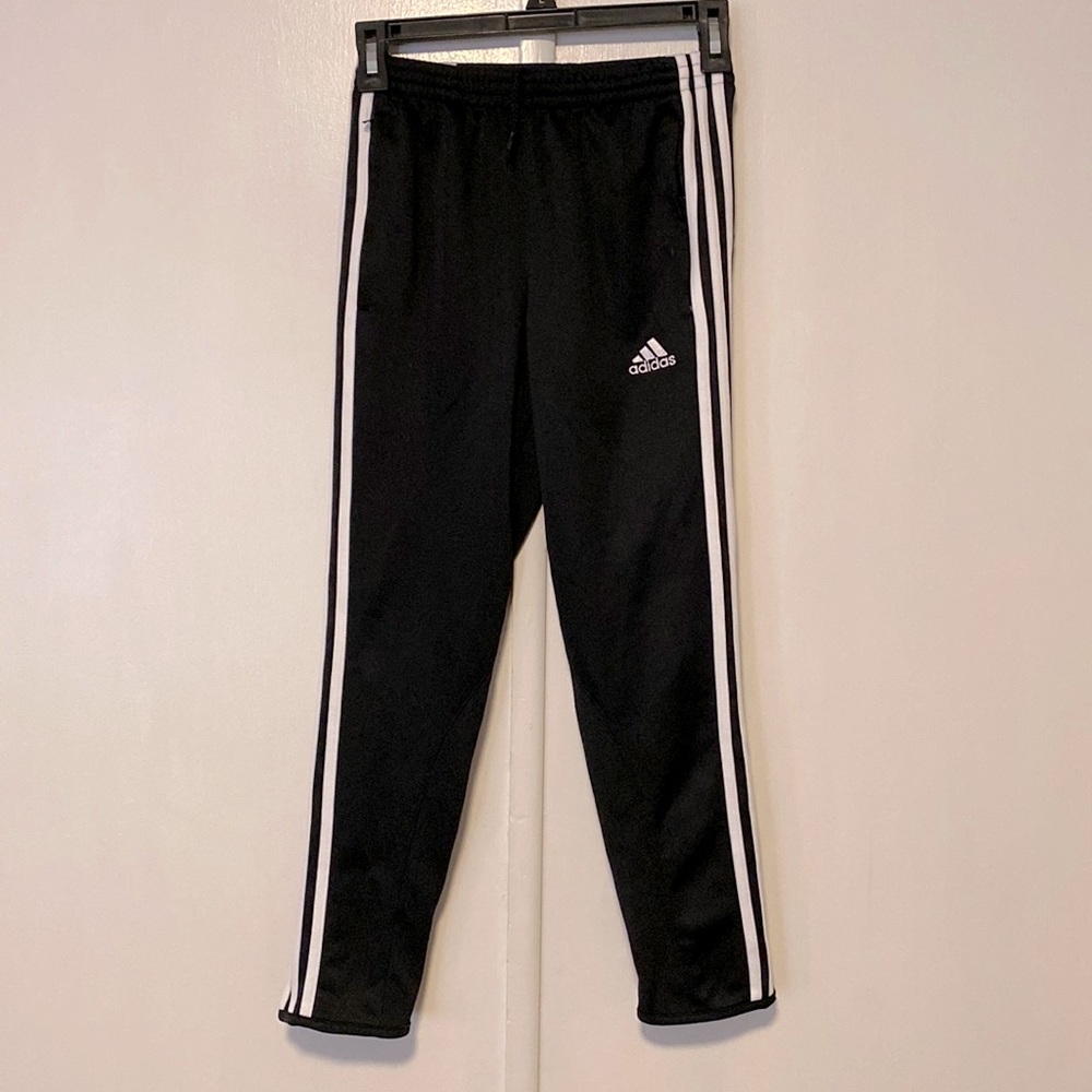 Adidas sweatpant with tie waste, zip pockets, and zip details on the lower leg